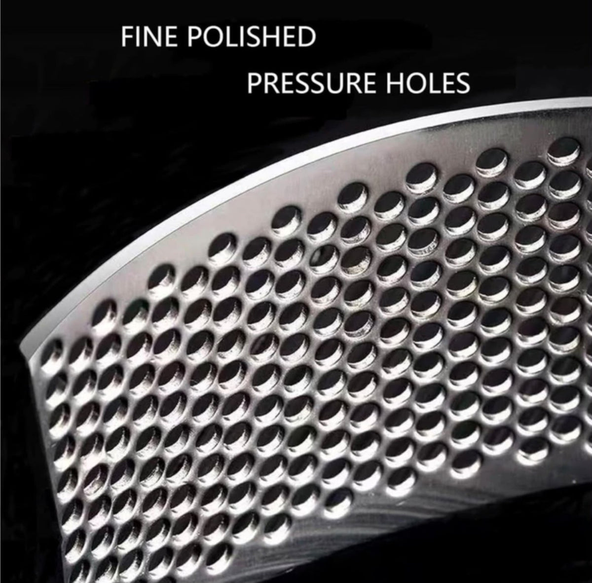Close-up of stainless steel garlic press pressing holes